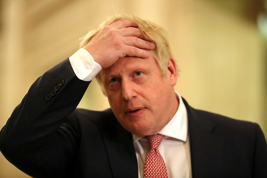 Boris Johnson runs his hands through his hair