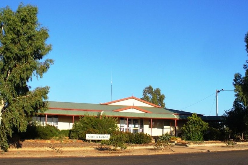 An image of the Shire of Yalgoo administration building, with blue skies and large trees.