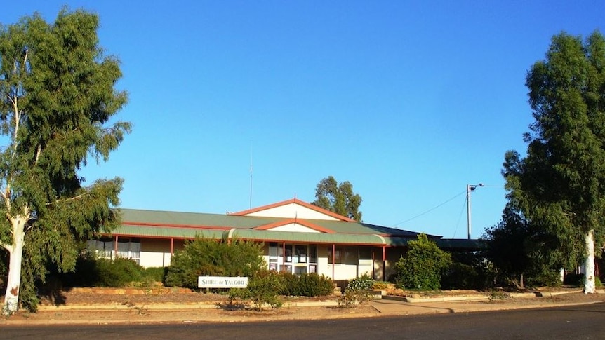 An image of the Shire of Yalgoo administration building, with blue skies and large trees.