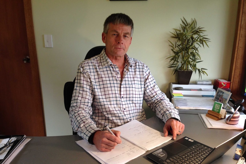 Ray Mostogl at desk.