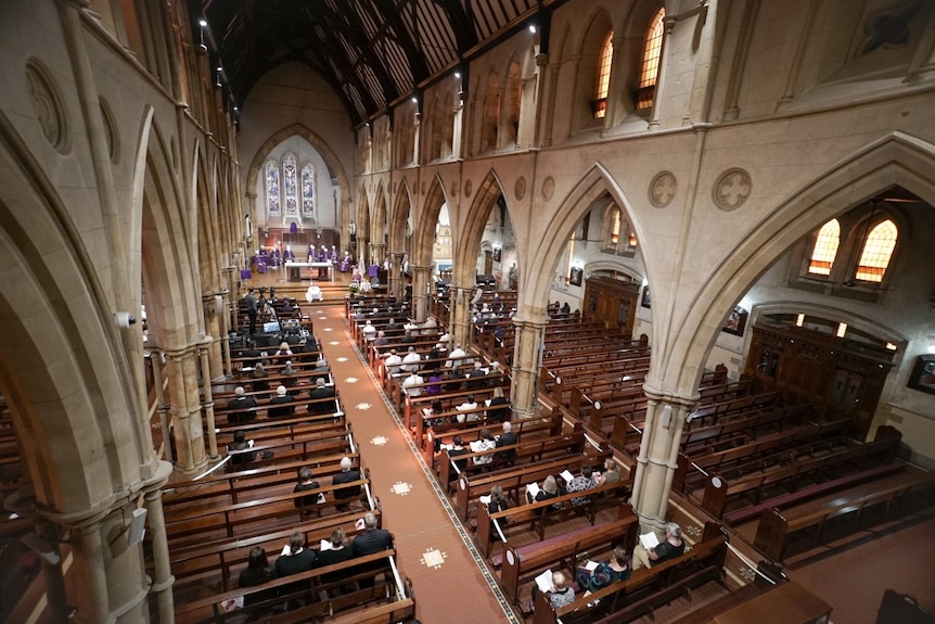 An aerial view of mourners sitting in pews at St Francis Xavier's Cathedral