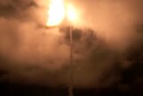 Rocket blasting into sky at night. 