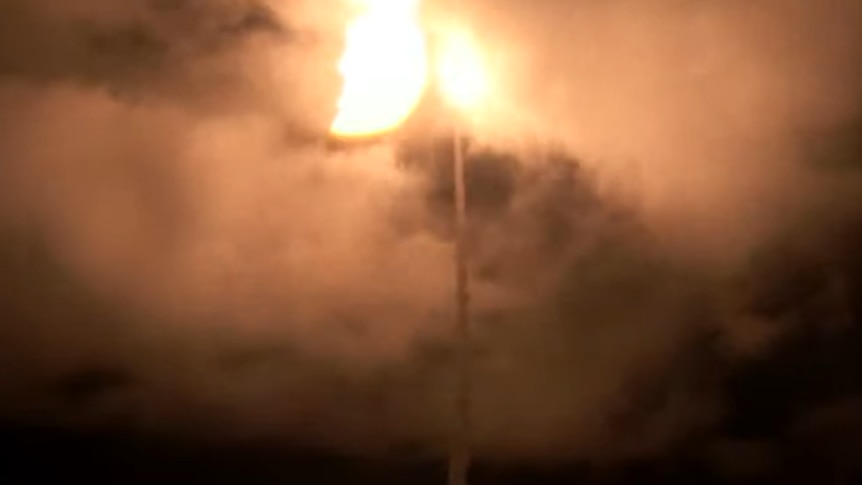 Rocket blasting into sky at night. 