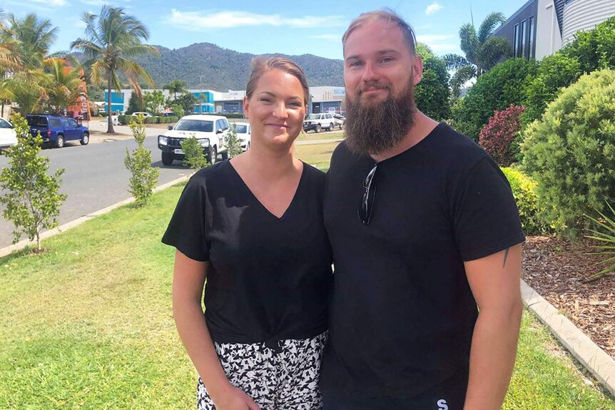Emma Andersson, stands with her partner Billy Ludvigsson, on a street in Airlie Beach in north Queensland