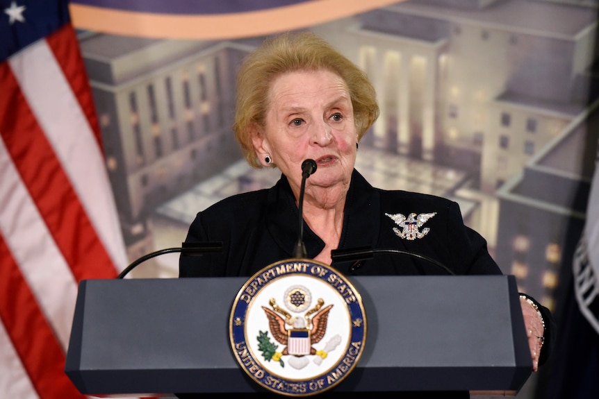 Former Secretary of State Madeleine Albright speaks at a reception from behind a podium.