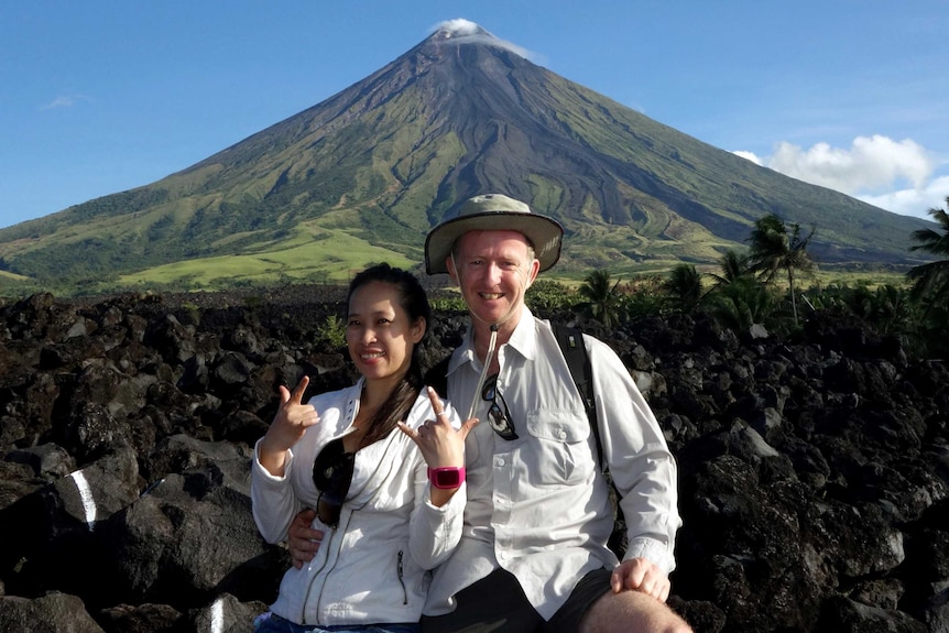 Michelle Abad and Ewen Marshall in front of the volcano