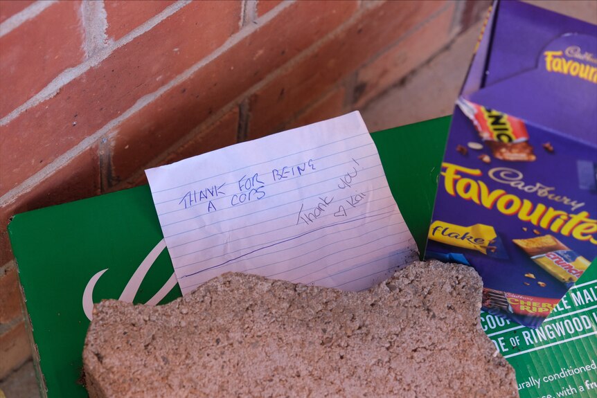 A handwritten note next to a box of Cadbury Favourites.
