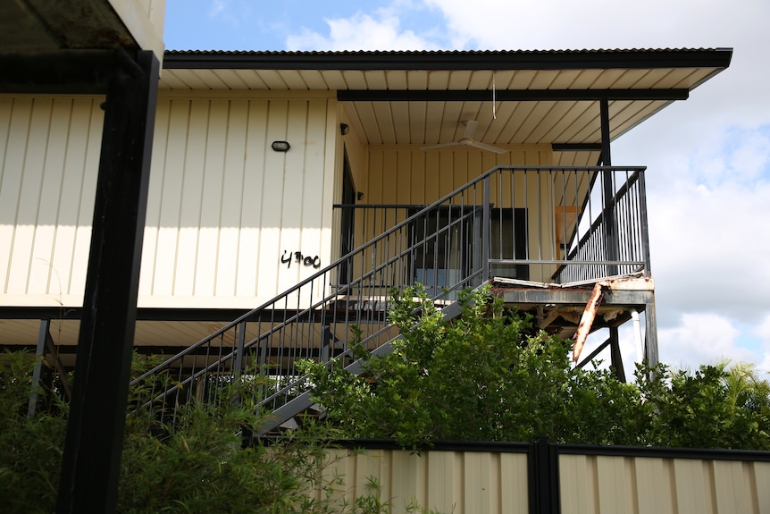 The balcony of a defective Palmerston home on a sunny day, with some damage visible.