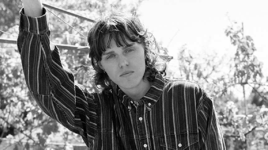 Black and white image of Allday, outdoors, wearing striped shirt