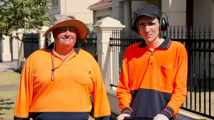 Support worker, Kerry, and Kosta Matsouliadis out the front of a house with a lawnmower