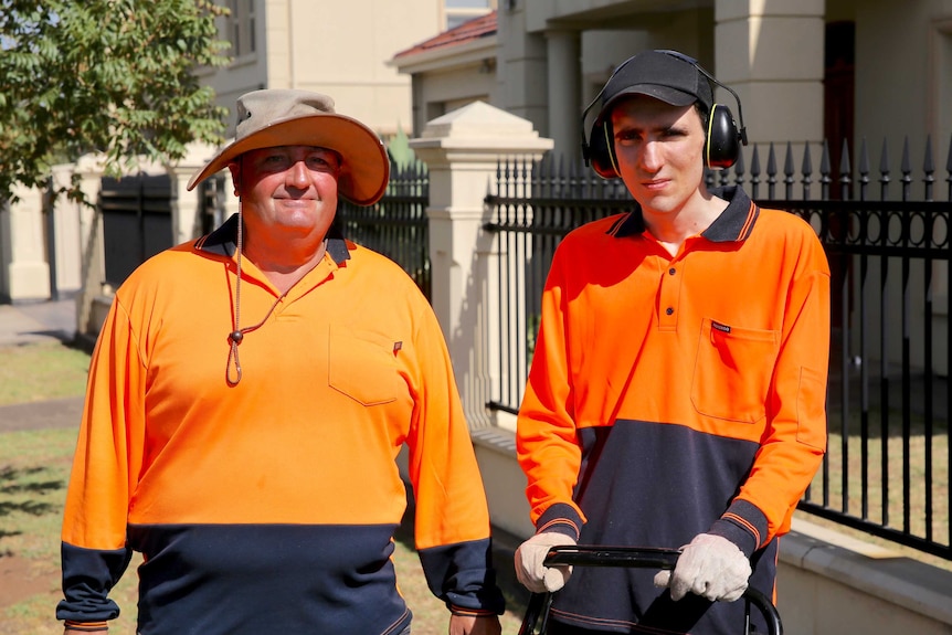 Support worker, Kerry, and Kosta Matsouliadis out the front of a house with a lawnmower