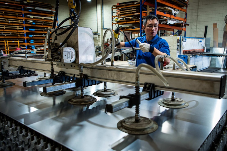 A man working on a machine in a factory