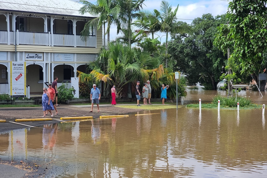 People looking at floodwater in Maryborough