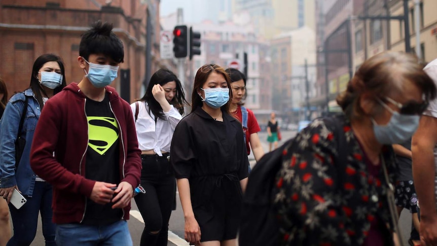 Pedestrians wear masks in Sydney's CBD