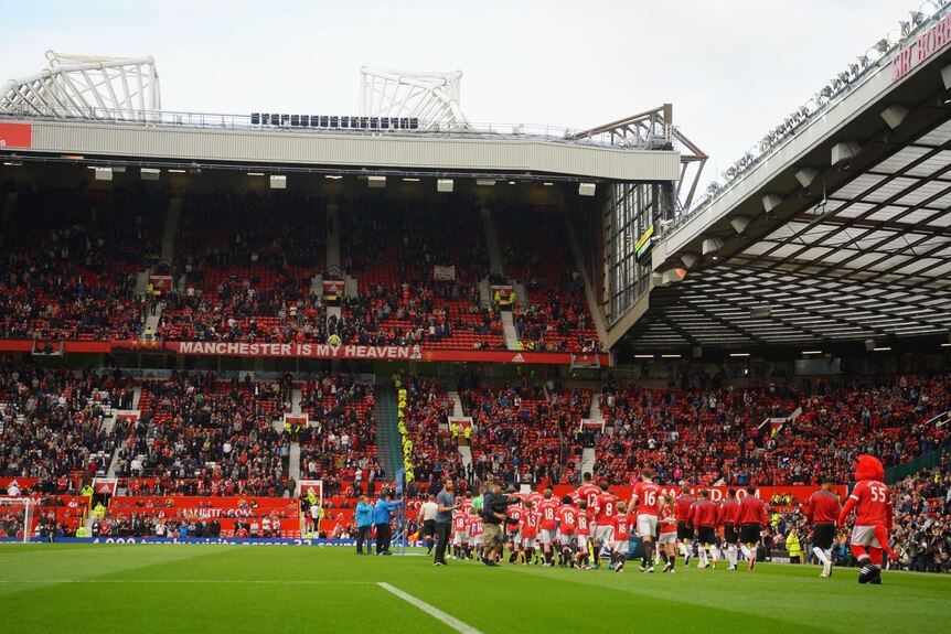 Teams walk out at Old Trafford in rescheduled fixture