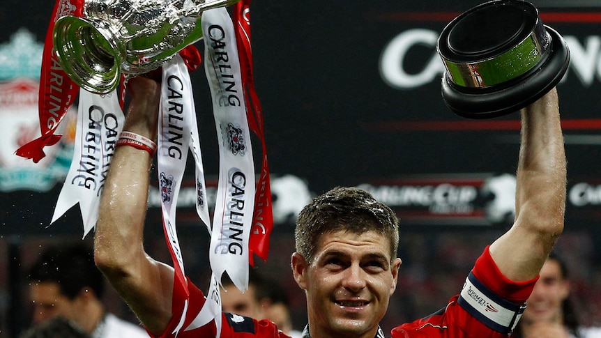 Steven Gerrard celebrates with the League Cup trophy