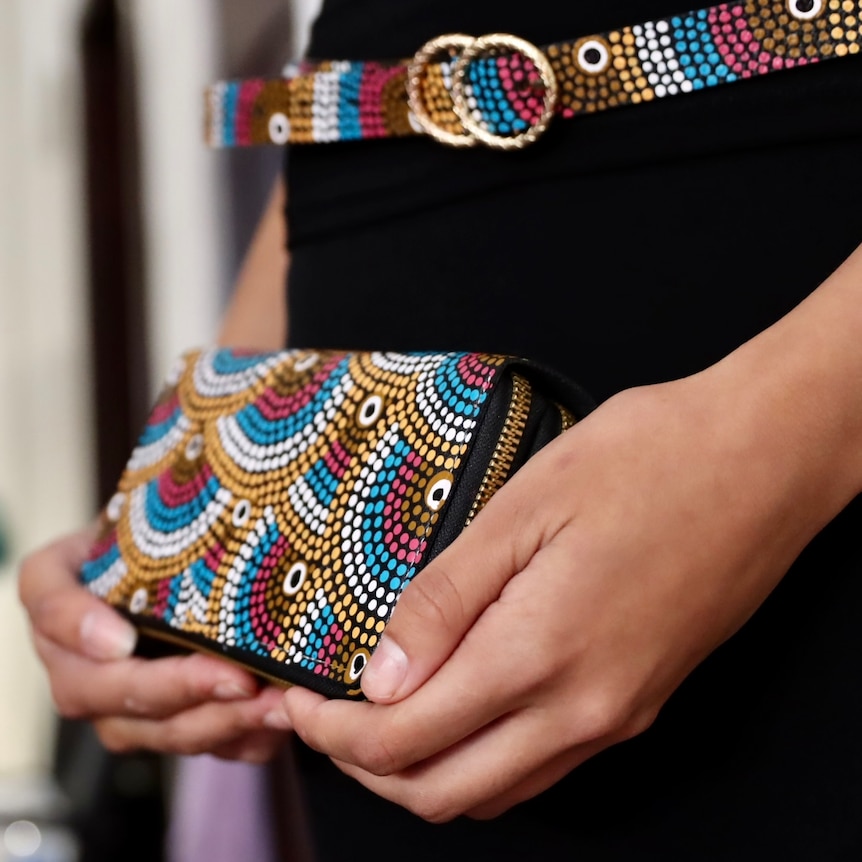 close up of purse and belt with colourful Aboriginal designs