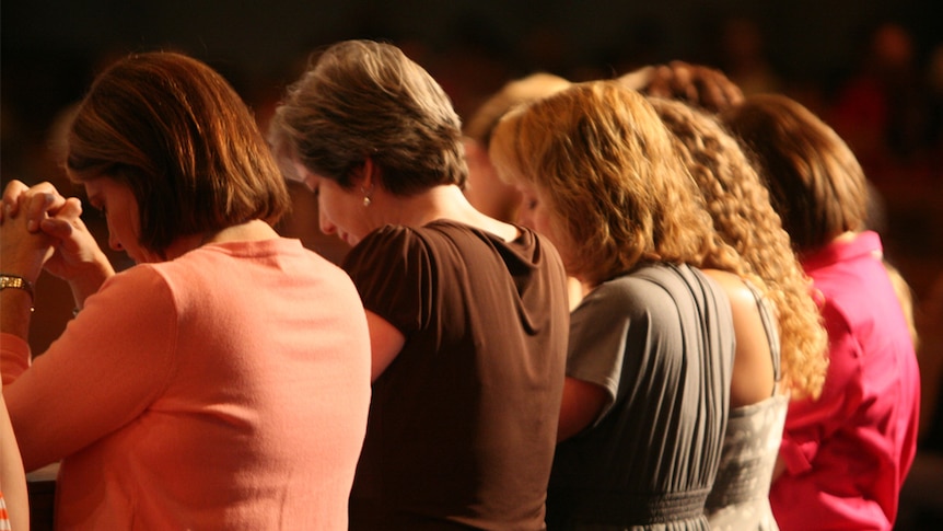 A group of women praying.