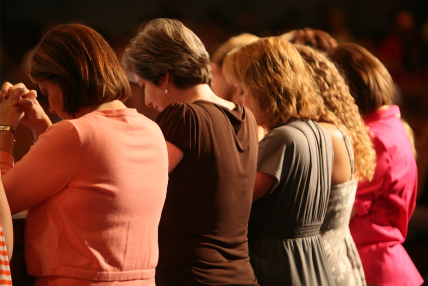 A group of women praying.