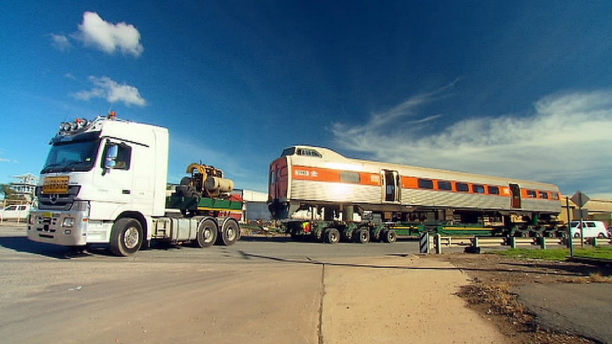 A railcar removed by truck from depot.
