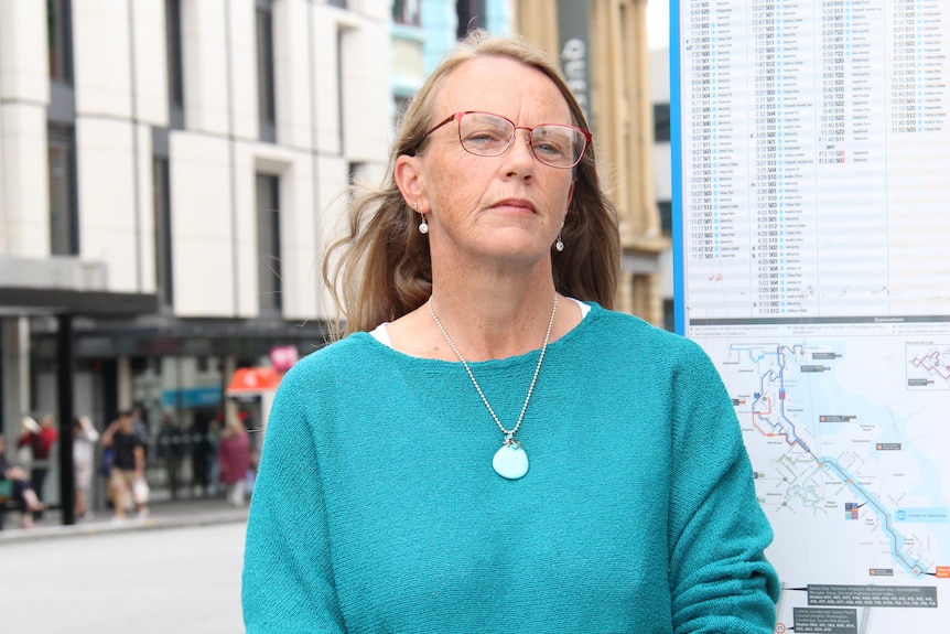 Kara Browning stands at a Hobart bus stop.