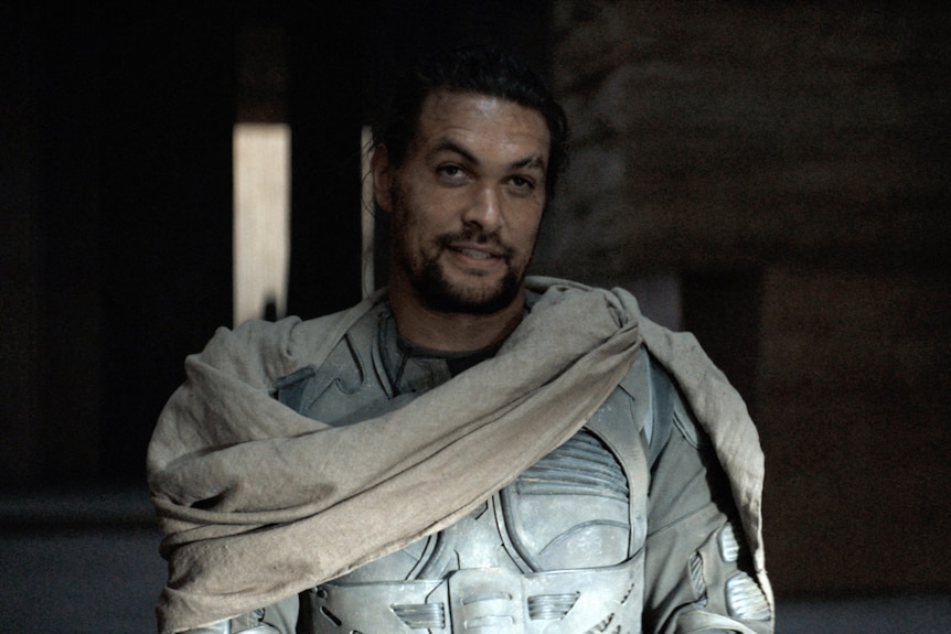 Jason Momoa dressed in a white futuristic suit of armour.