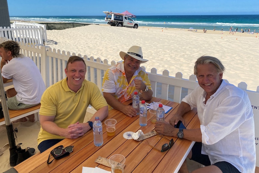 Gold Coast mayor Tom Tate and Queeunsland premier Steven Miles enjoy a beer at the Kurrawa Beach Club.