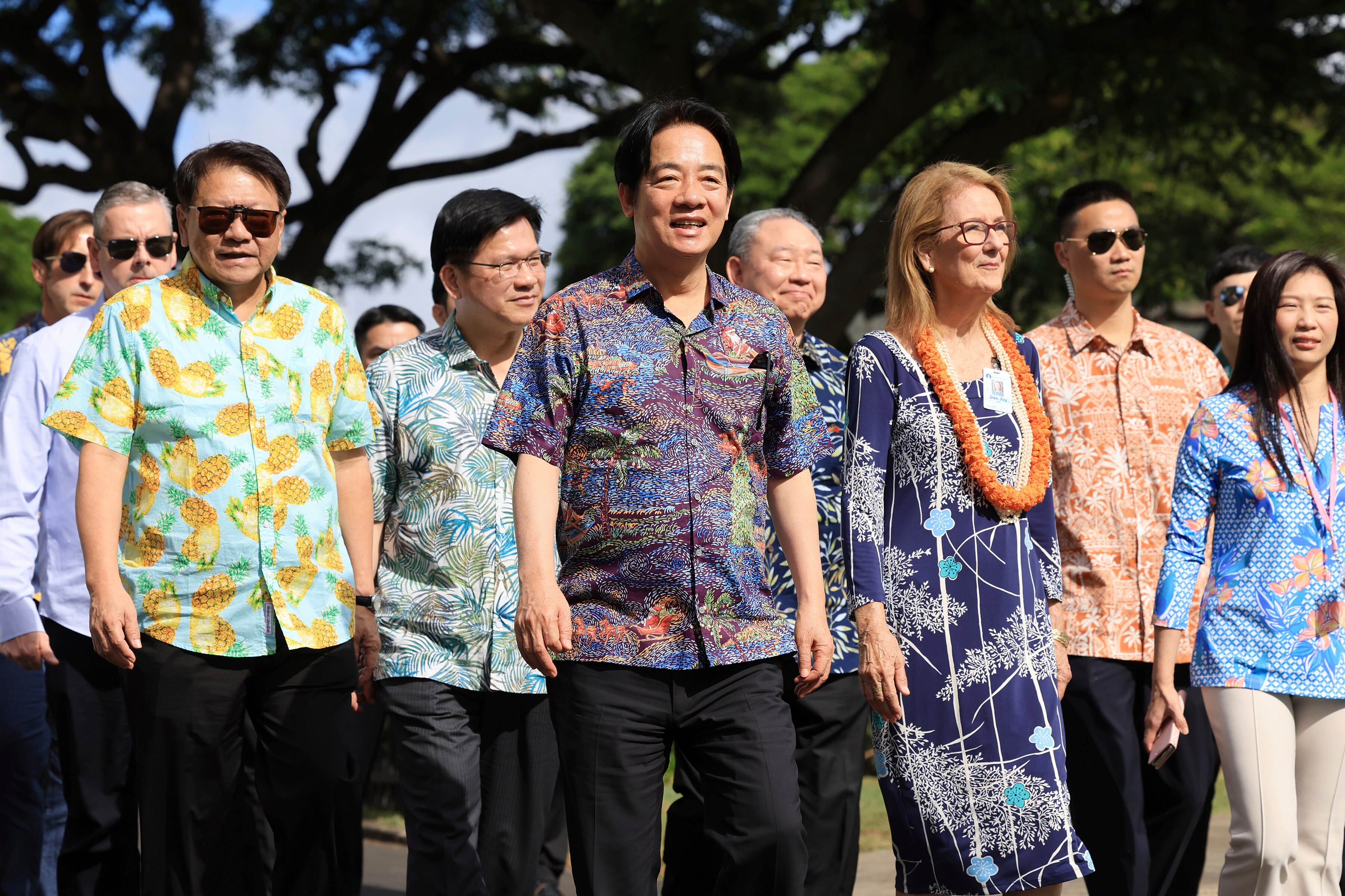 A group of people wearing colourful shirts.