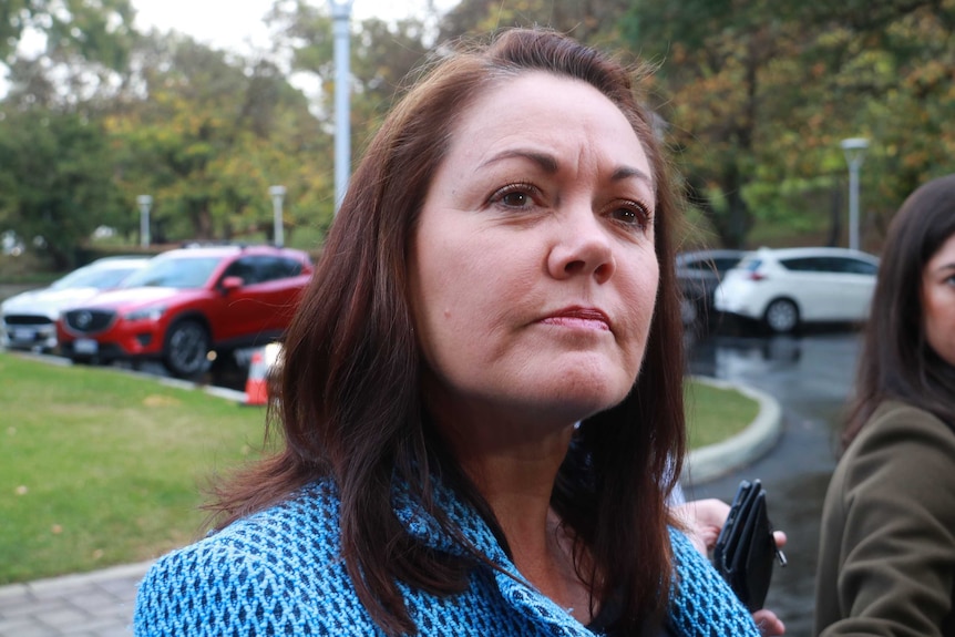 Liza Harvey looks up in front of Parliament House.