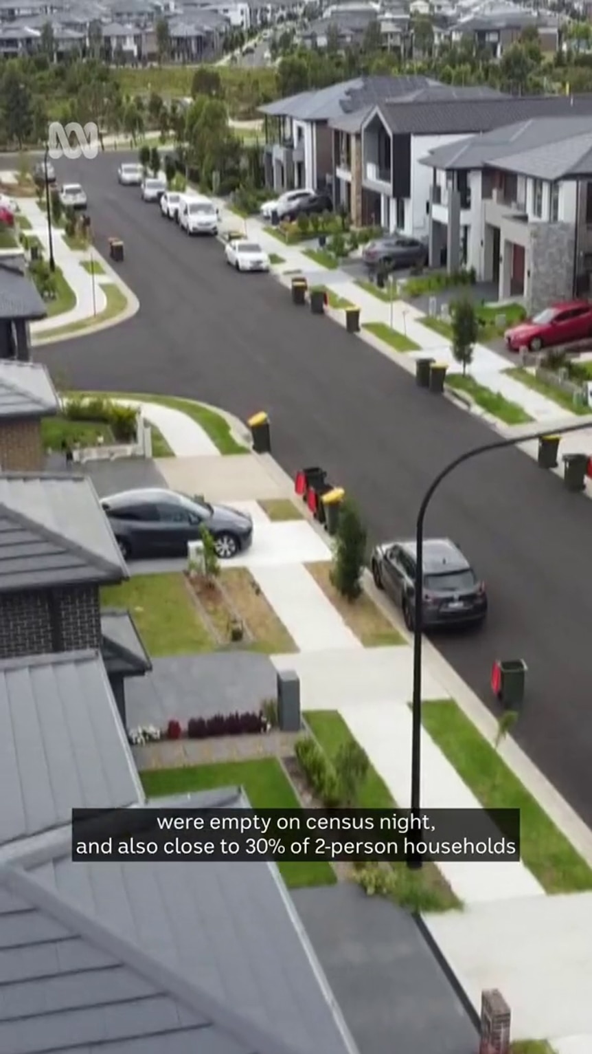 Aerial photo shows a new suburban street with green lawns and bins out on street
