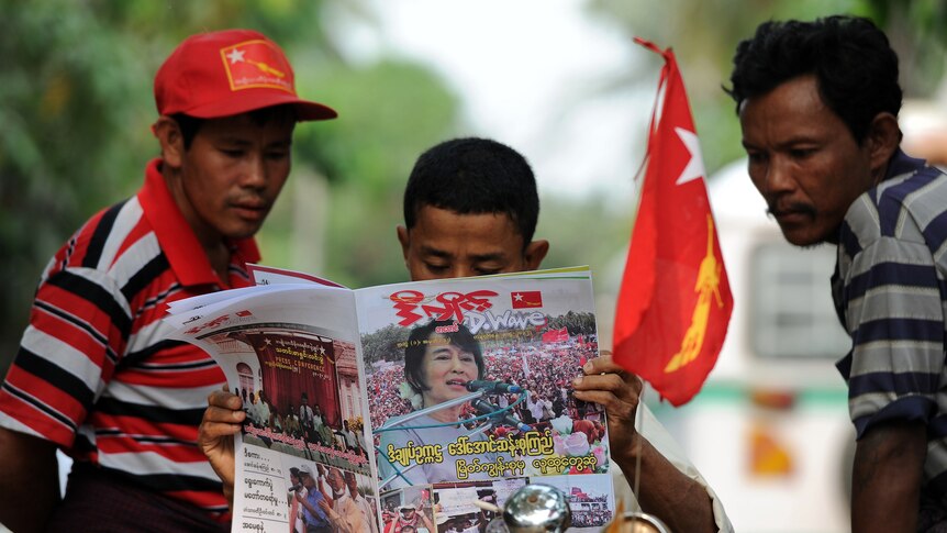 Men read a newspaper in Burma