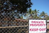 A fenced off resort featuring a sign that says 'Private property: keep out'.