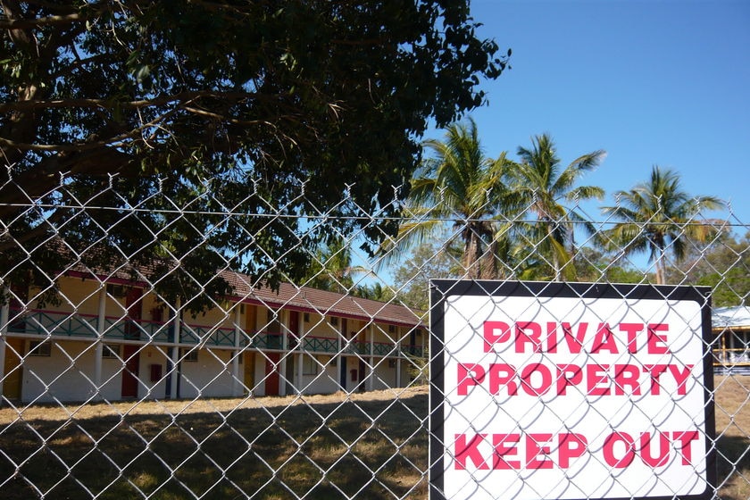 A fenced off resort featuring a sign that says 'Private property: keep out'.