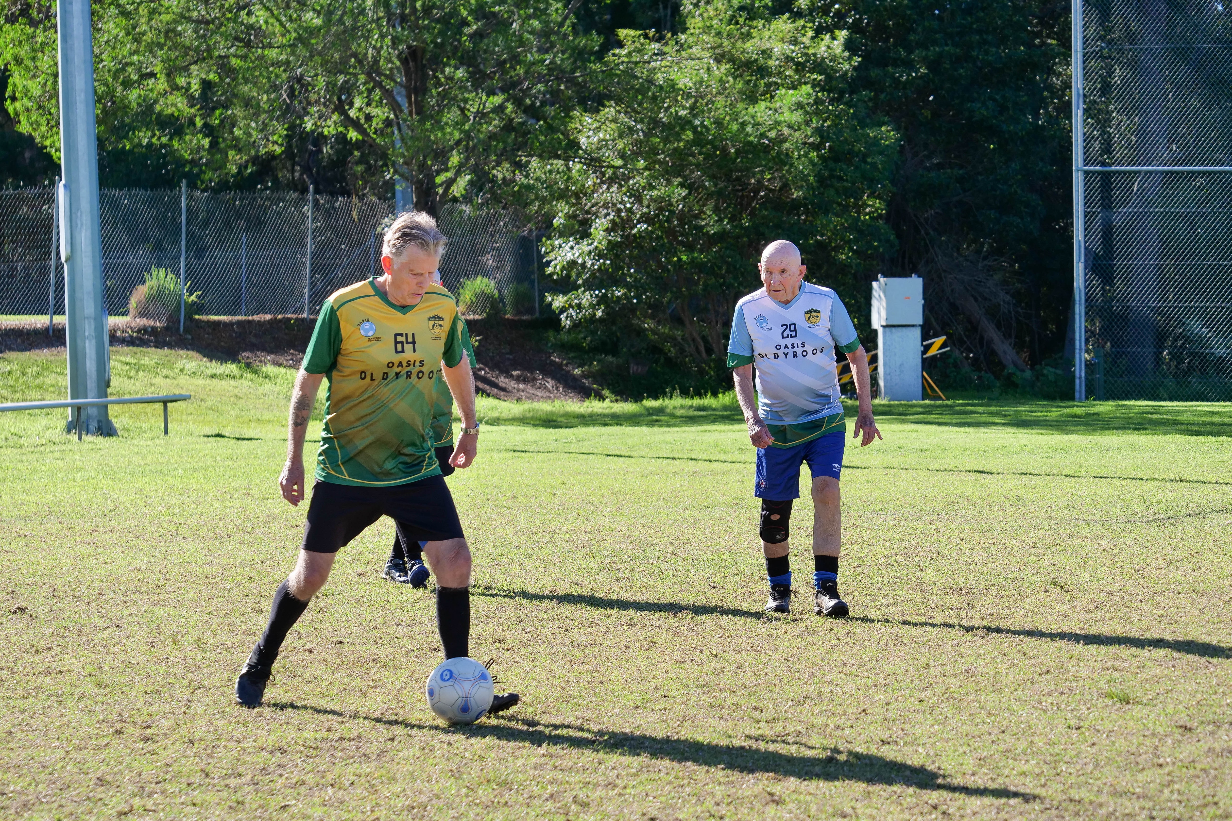 an older football player looks to kick the ball