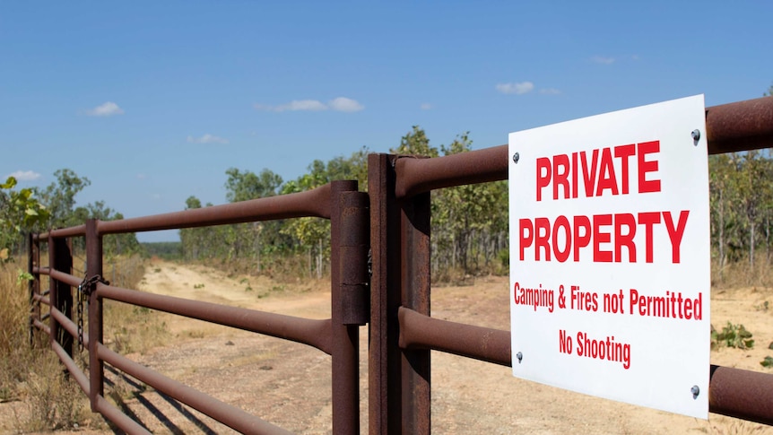a sign reading private property on a gate.