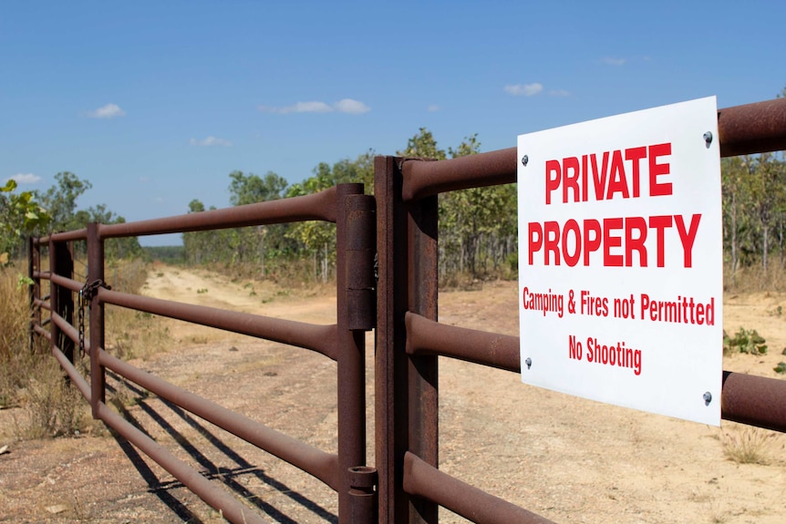 a sign reading private property on a gate.