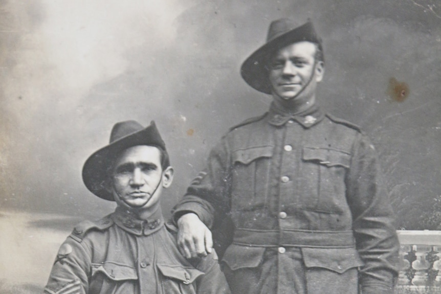 Australian soldiers George Slatter, sitting on a chair, and Jock Pender, standing alongside dressed in uniforms before WWI.