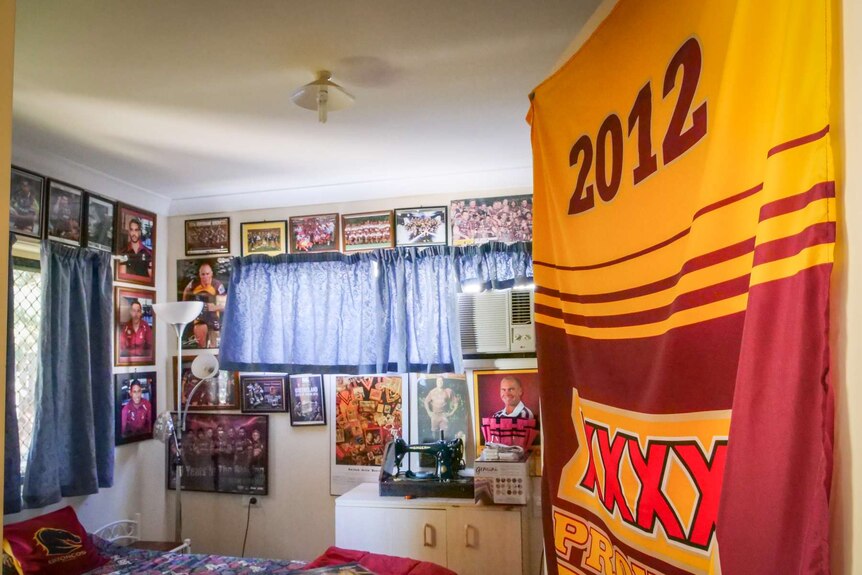 A bedroom covered in posters and flags.