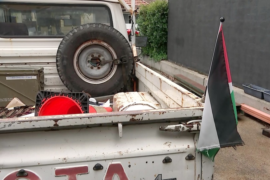 a palestinian flag is flown on the back of a car in sydney's botany