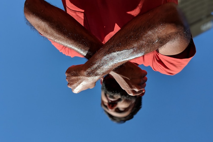 Nakul crosses his arms in the sun for a story about sunscreen and darker skin