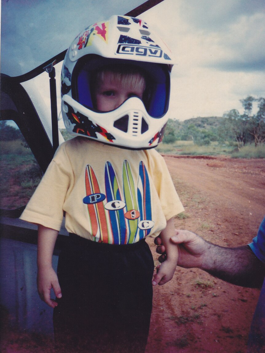 Harrison Creevey wearing a motorbike helmet at three years of age.
