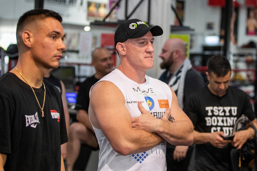 Paul Gallen stands with his arms folded next to Tim Tszyu