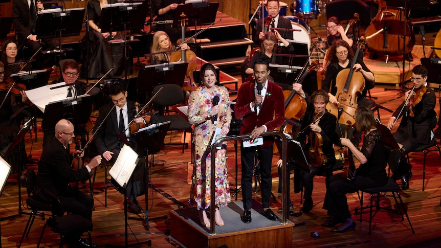 Megan Burslem and Jeremy Fernandez hosting the Classic 100 in concert, onstage with the MSO.