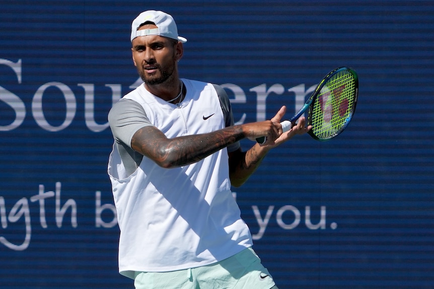 A serious-looking Nick Kyrgios brings his racquet through to complete a forehand during a match in Cincinnati.
