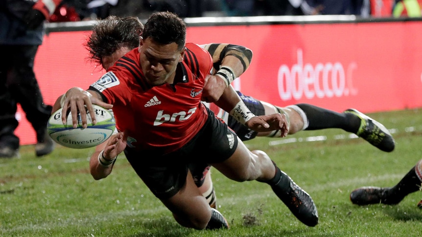 Seta Tamanivalu dives for the corner whilst being tackled with his arm outstretched with the ball.