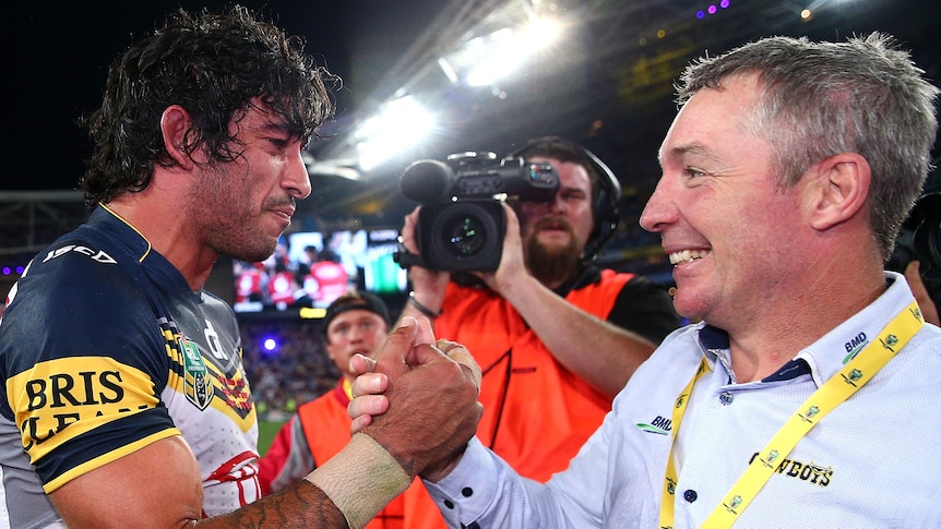 North Queensland Cowboys coach Paul Green clasps hands with Johnathan Thurston after the 2015 NRL grand final.