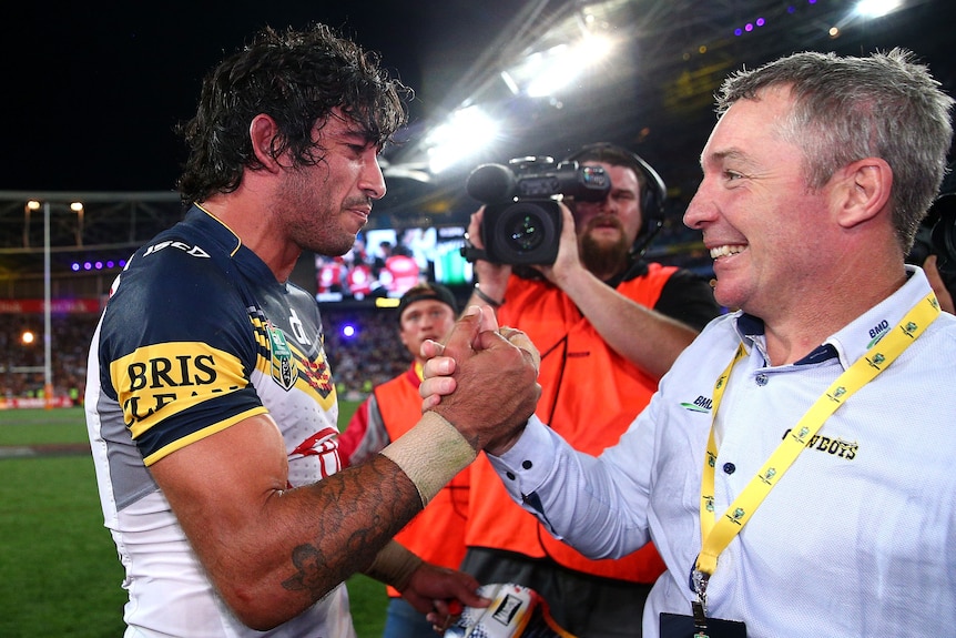 North Queensland Cowboys coach Paul Green clasps hands with Johnathan Thurston after the 2015 NRL grand final.