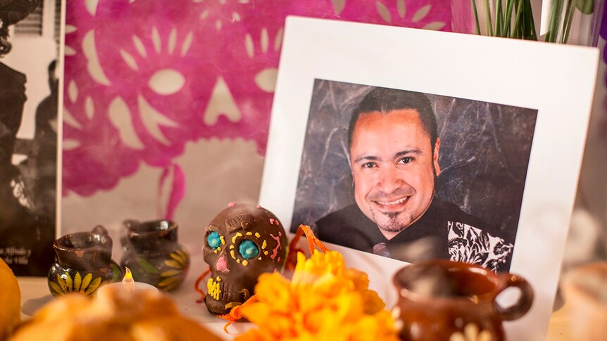 A photograph of a lost loved one on a Mexican home altar.