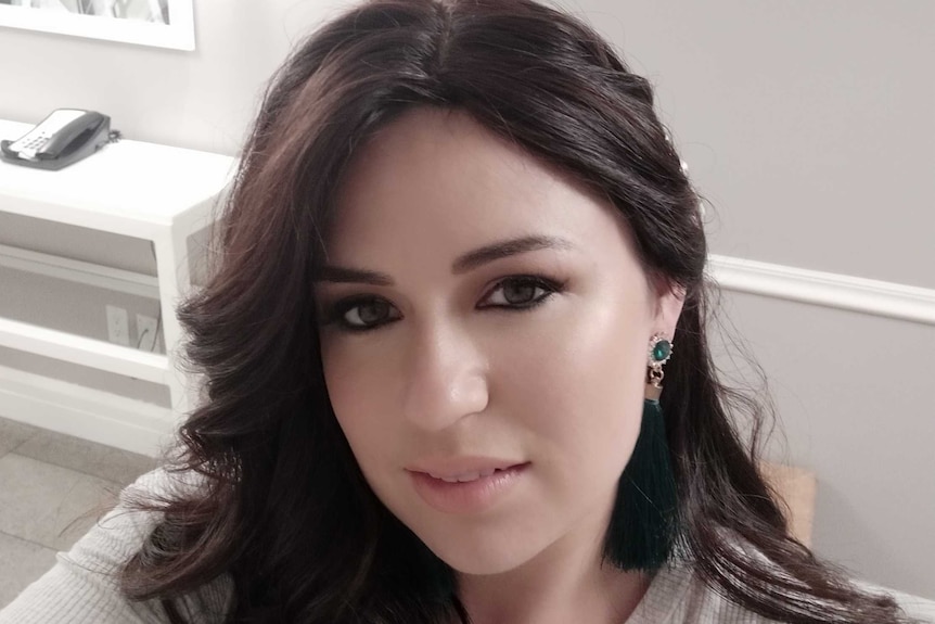 High angle portrait of a young woman with dark long wavy hair