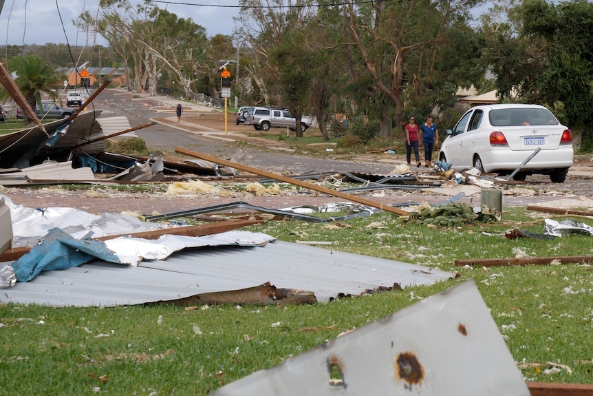 A street in a regional town strewn with debris after a cyclone.